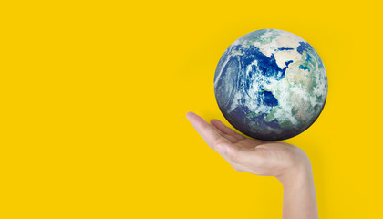 Globe ,earth in  hand, holding our planet glowing. Earth image provided by Nasa
