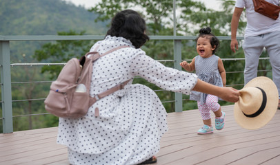 mother and little daughter playing together in a park