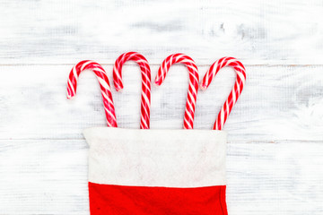 Christmas candy cane on white wooden background. Flat lay