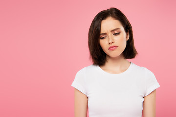 beautiful sad girl isolated on pink