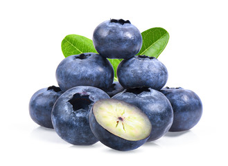 Blueberries with green leaves closeup, isolated on white background