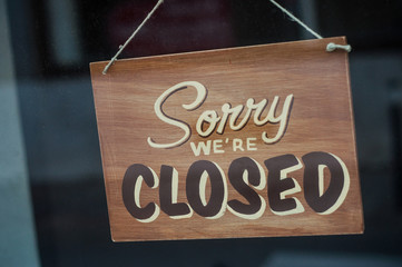 Closeup of wooden panel on store front : Sorry we are closed - 292907397