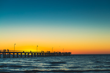 Fototapeta na wymiar Semaphore pier with people at sunset, South Australia