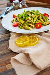 Pasta with pesto sauce and nuts on a the table