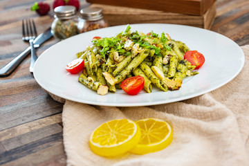 Pasta with pesto sauce and nuts on a the table