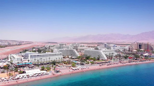 Aerial footage over Eilat City Coastline Hotels and desert mountains Drone footage over Eilat Shorline With sea hotels and desert mountains