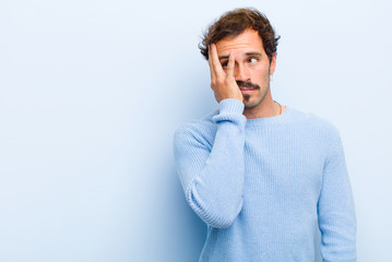 young handsome man feeling bored, frustrated and sleepy after a tiresome, dull and tedious task,...