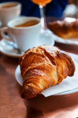 Breakfast with coffee and croissants on table