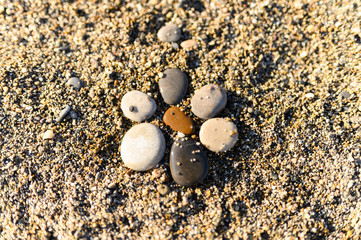 arrangement of colored sea stones and sand