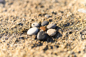 arrangement of colored sea stones and sand