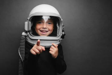 Small child wants to fly an airplane wearing an airplane helmet