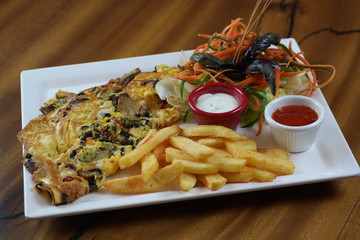 Omelette with vegetables and french fries