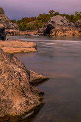 Potomac river flowing through the rocks on moody autumn morning in Virginia near DC
