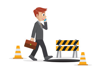 businessman talking on a cell phone and he does not see the hole in front.