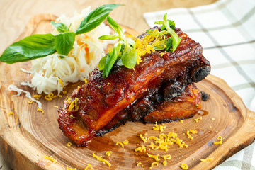 Close up on Baked pork ribs in honey sauce and sauerkraut. Beer snack. Close up. Selective focus