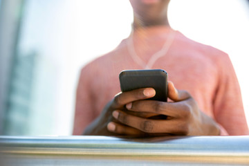 Close up of african american male hands holding mobile phone