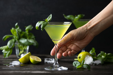 Gimlet cocktail with fresh basil leaves