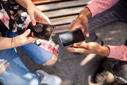 Above Of African American Male Hands Caucasian Female Hands Holding Phone