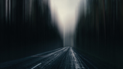 asphalt road in a gloomy surreal forest. highway in a gloomy eerie landscape.