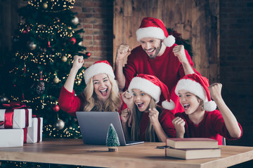 Photo of excited parents sister brother sitting table indoors reading notebook x-mas unbelievable...
