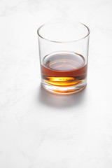 scotch whiskey in glass on a white mable table with a blank space for a text, scotch whiskey in bar background