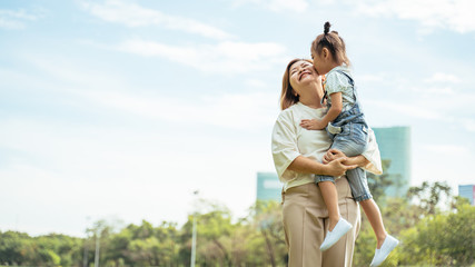 Nice little girl run to grandmother's hug in park.Grandmother and grand daughter enjoying sunny garden holiday together, outdoors space, leisure lifestyle,happy teaching with flare light sky in park.
