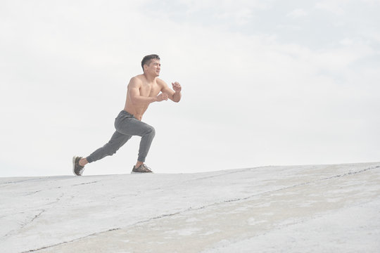 Asian athlete training outdoors in the morning, photo of Kazakh wrestler's workout in style of minimalism
