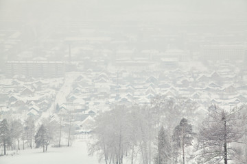 Fototapeta na wymiar scenic winter landscape background. view of the snow-covered town, houses and trees.