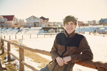 outdoor portrait of a young handsome man. winter village.