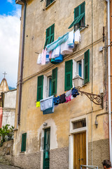 Fototapeta na wymiar Riomaggiore, Cinque Terre, Italy - August 17, 2019: City narrow streets with colorful houses, a resort town in Europe on the shore of the Ligurian Sea