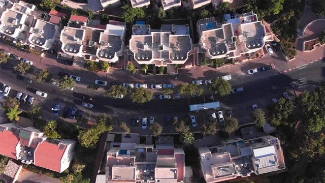 Top down Aerial view of Curvy road and rooftops Drone footage over neighbourhood Main street Curvy road and rooftops