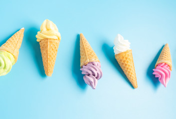 Colorful sweet ice cream cone isolated on blue pastel background ,holiday and relax concept