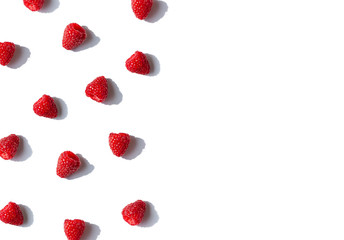 Raspberries frame with shadows on the white background. Top view. Copy space