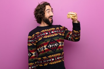 young crazy bearded man having a burger