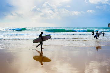 Fototapeta na wymiar Surfers surfboards silhouette Portugal Algarve