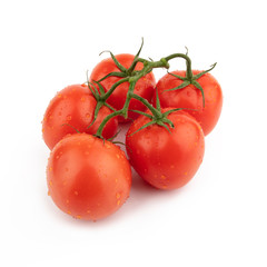 Group red tomatoes whole on a green branch. Isolated on a white background.