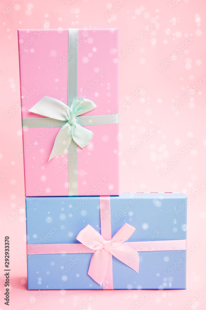 Poster multi-colored boxes with bows on a pink background