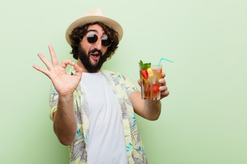 young crazy bearded man with a cocktail. tourist concept