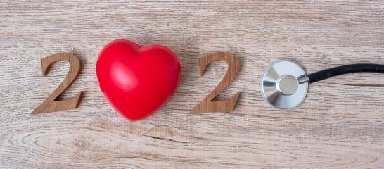 2020 Happy New Year for healthcare, Wellness and medical concept. Stethoscope with red heart and wooden number on table background