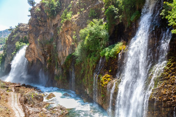 Kapuzbasi Waterfall in Aladaglar National Park Green trees round the waterfall soups composition.
