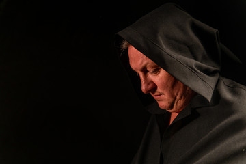 Portrait of a courageous warrior wanderer in a black cloak. Historical fantasy. Halloween.