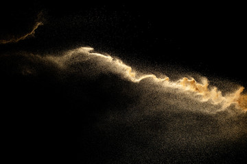 Brown dry river sand explosion isolated on black background. Abstract sand splash.