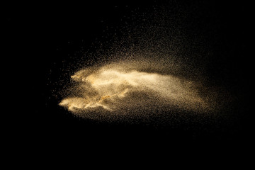 Brown dry river sand explosion isolated on black background. Abstract sand splash.