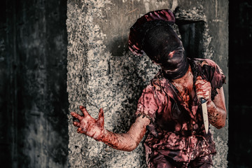Ghost nurse woman or zombie holding the knife with resentment and malice in the building abandoned...