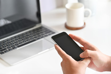 Man's Hands Using Smartphone on Office Desk.