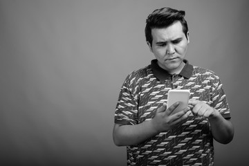 Young multi ethnic man against gray background