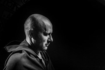 Portrait of a courageous warrior wanderer in a black cloak. Historical fantasy. Halloween