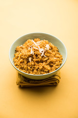 Wheat Laapsi/Lapsi/Shira/Halwa is an Indian sweet dish made of broken wheat or Daliya pieces and ghee along with nuts, raisins and dried fruits. It's a healthy food. served in a bowl, selective focus