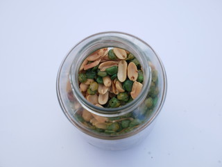 peas on white background, nut and beans in a glass jar