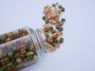 peas on white background, nut and beans in a glass jar
